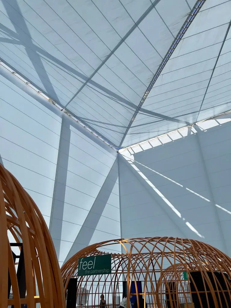 Interior of a deployed Kuafo roof top tent with thick mattress and warm light
